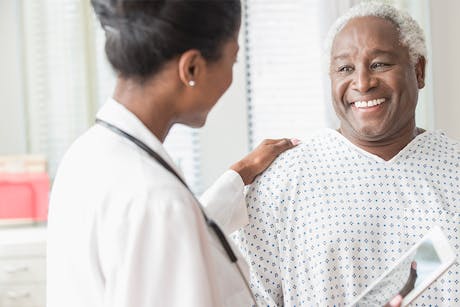 Doctor with a male patient discussing colon cancer screenings